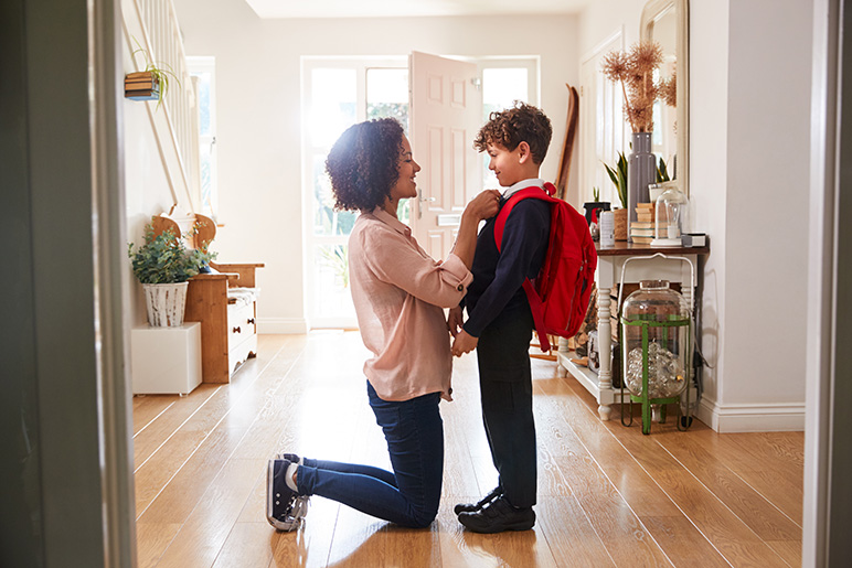 Mom gets her son ready for the first day of school