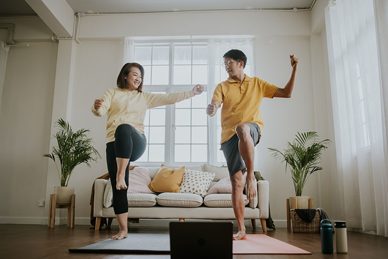 A couple working out together in their living room