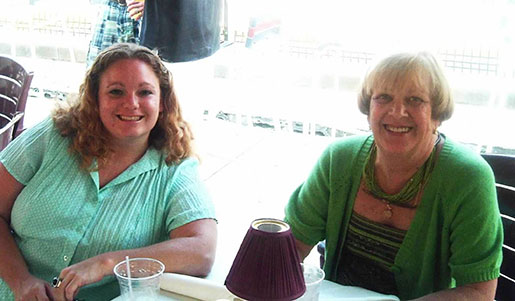 Amy Kraft and her mom at a table smiling