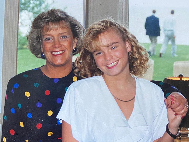 Amy Kraft and her mom holding hands smiling