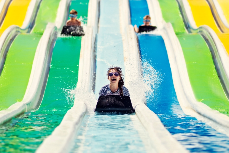 Kids having fun on a water slide at a water park