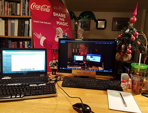 A work from home office that has Christmas decorations all over the room the desk is in