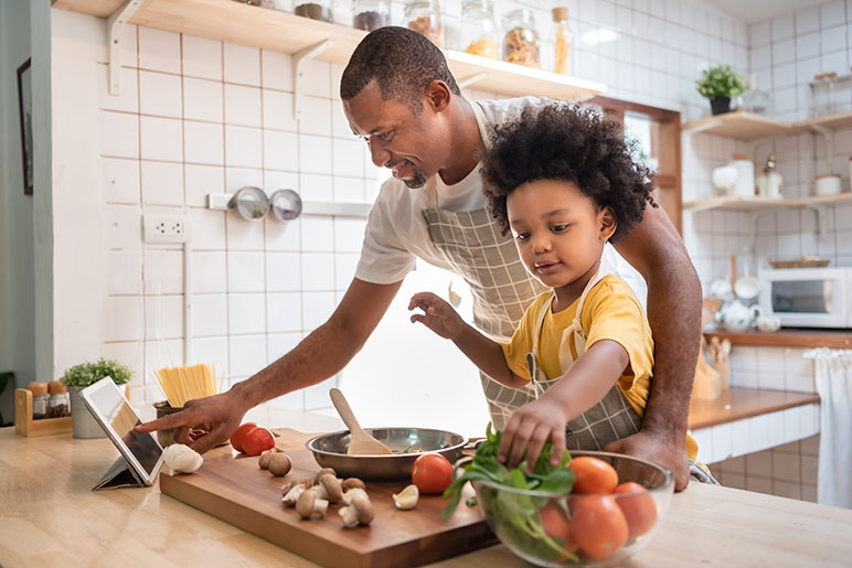 father and son cooking in the kitchen to have a healthy new year