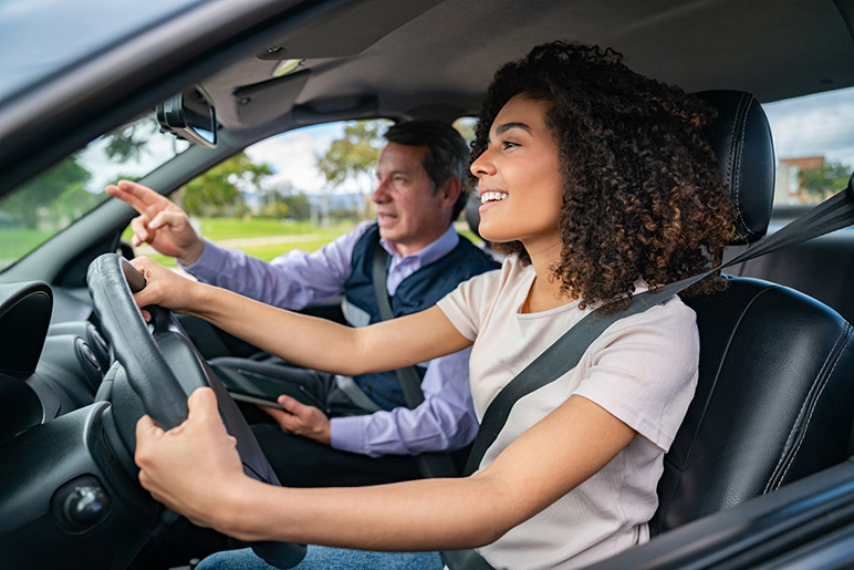 Student driver learning how to drive with instructor
