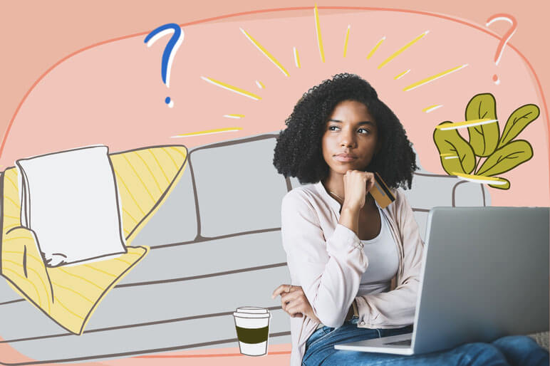 Girl sitting on the floor looking curious with a laptop on her lap