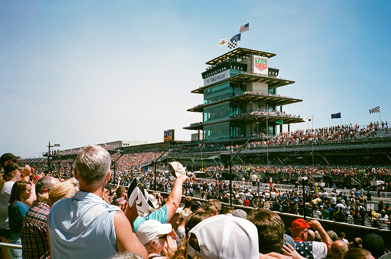 Fans watch the Indianapolis 500 at the Indianapolis Motor Speedway