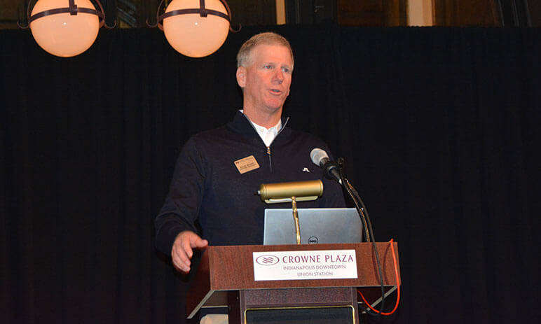 Kevin Murphy giving a speech at a podium 