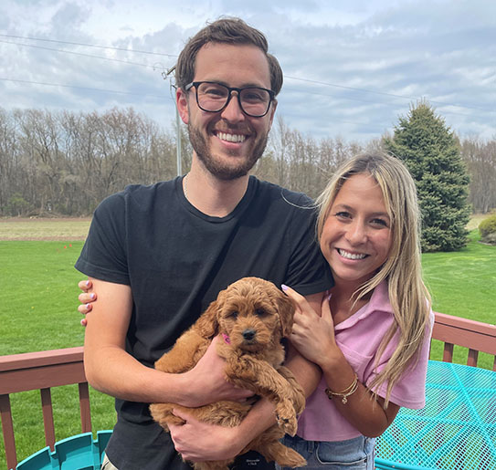 Samantha and Conner Andersen holding their new puppy