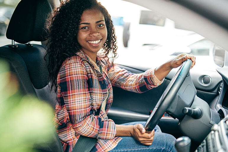 Teenager in the driver's seat of her car getting ready to drive