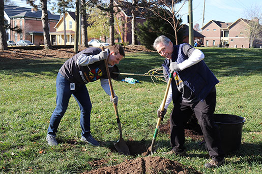 Two Indiana Farm Bureau Insurance employees planting trees with Keeping Indianapolis Beautiful (KIB)