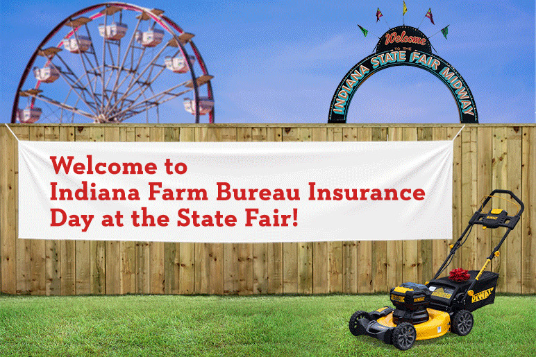 Welcome to Indiana Farm Bureau Insurance Day at the State Fair banner on a fence next to a push lawn mower and a Ferris wheel and Indiana State Fair Midway sign