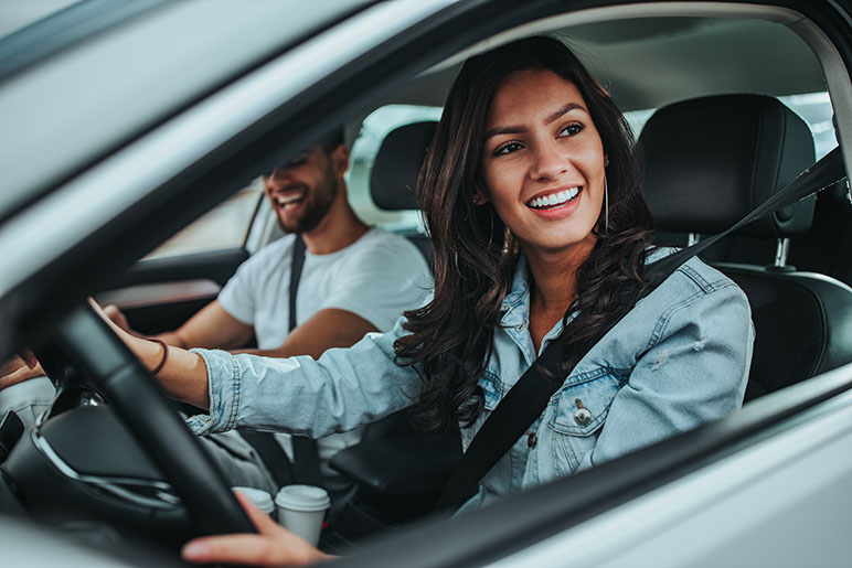 Woman and man in car smiling