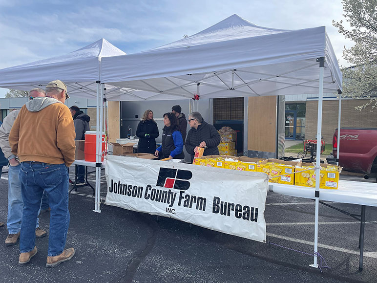 Agents Alice and Kim from Indiana Farm Bureau Insurance handing out food in Johnson County