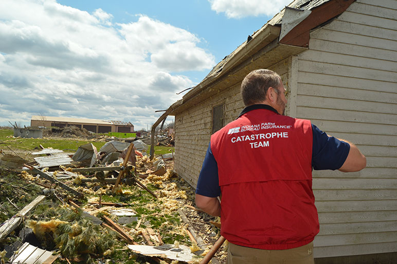 Indiana Farm Bureau Insurance claims representative assessing damage from the Sullivan storms