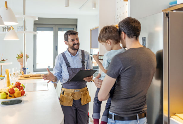 Happy insurance adjuster explaining insurance benefits to family