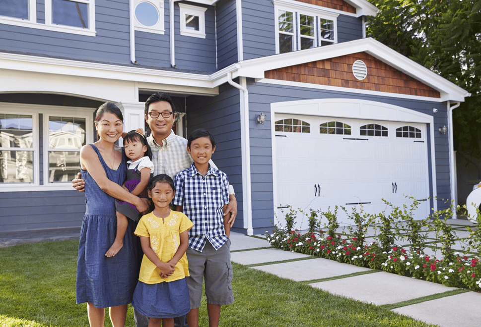 happy family in front of house